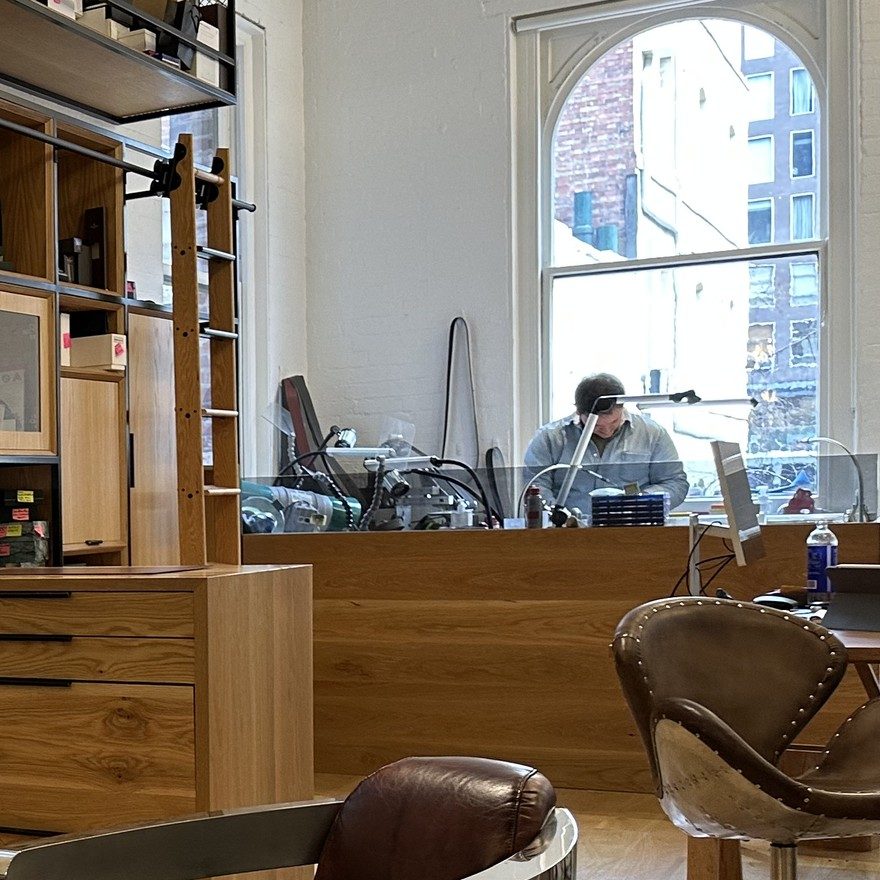 The watchmaker at the bench at the back of the Melbourne shop
