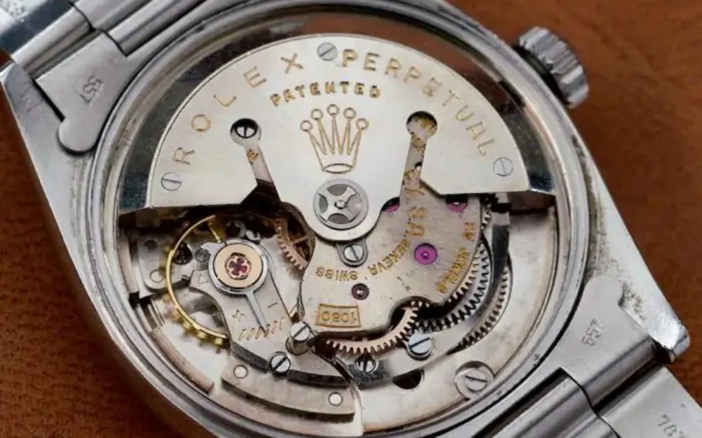 Close view of the movement inside an open Rolex watch.