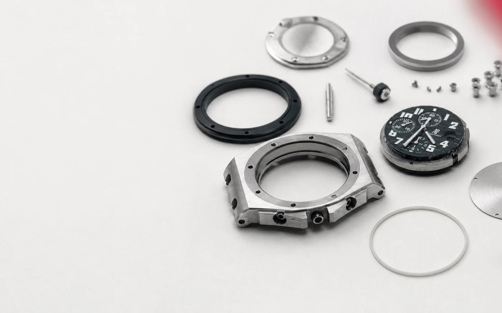 Disassembled wristwatch components arranged for service.