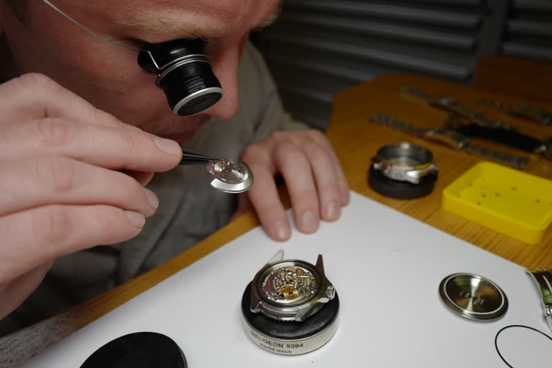 Inspecting the rotor post on a Rolex 3135 calibre at the workshop