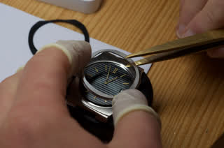 Nautilus 3700/8 crystal lifted with tweezers on the bench